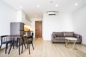 Standard Apartment, City View | Living area | Smart TV, Netflix, streaming services - Fusion Riverside Apart Near Ben Thanh (Ho Chi Minh City)