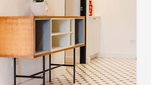 Un baño moderno con tocador de madera, un espejo y una orquídea en maceta.