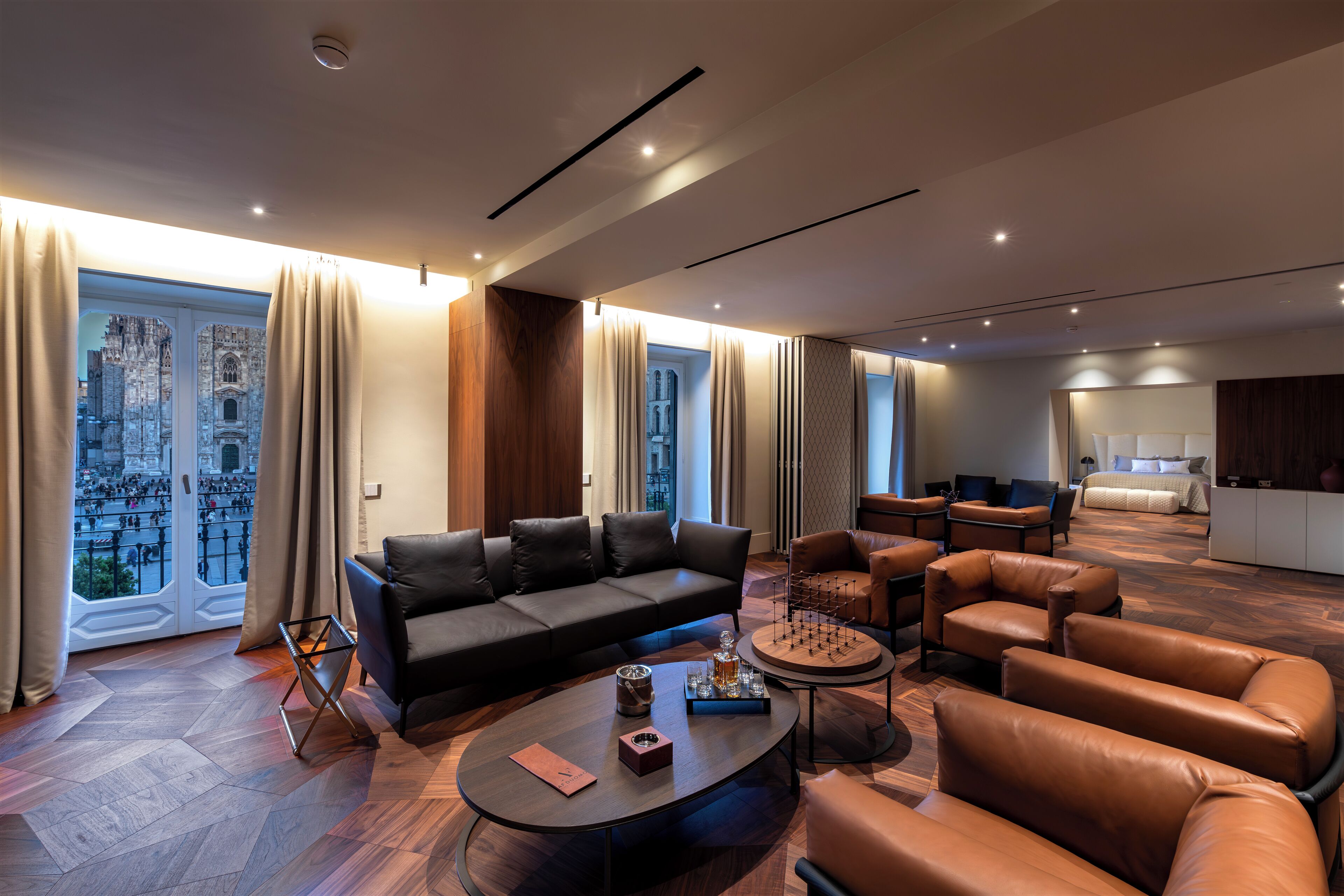A modern living room with a sofa, armchairs, and a coffee table.