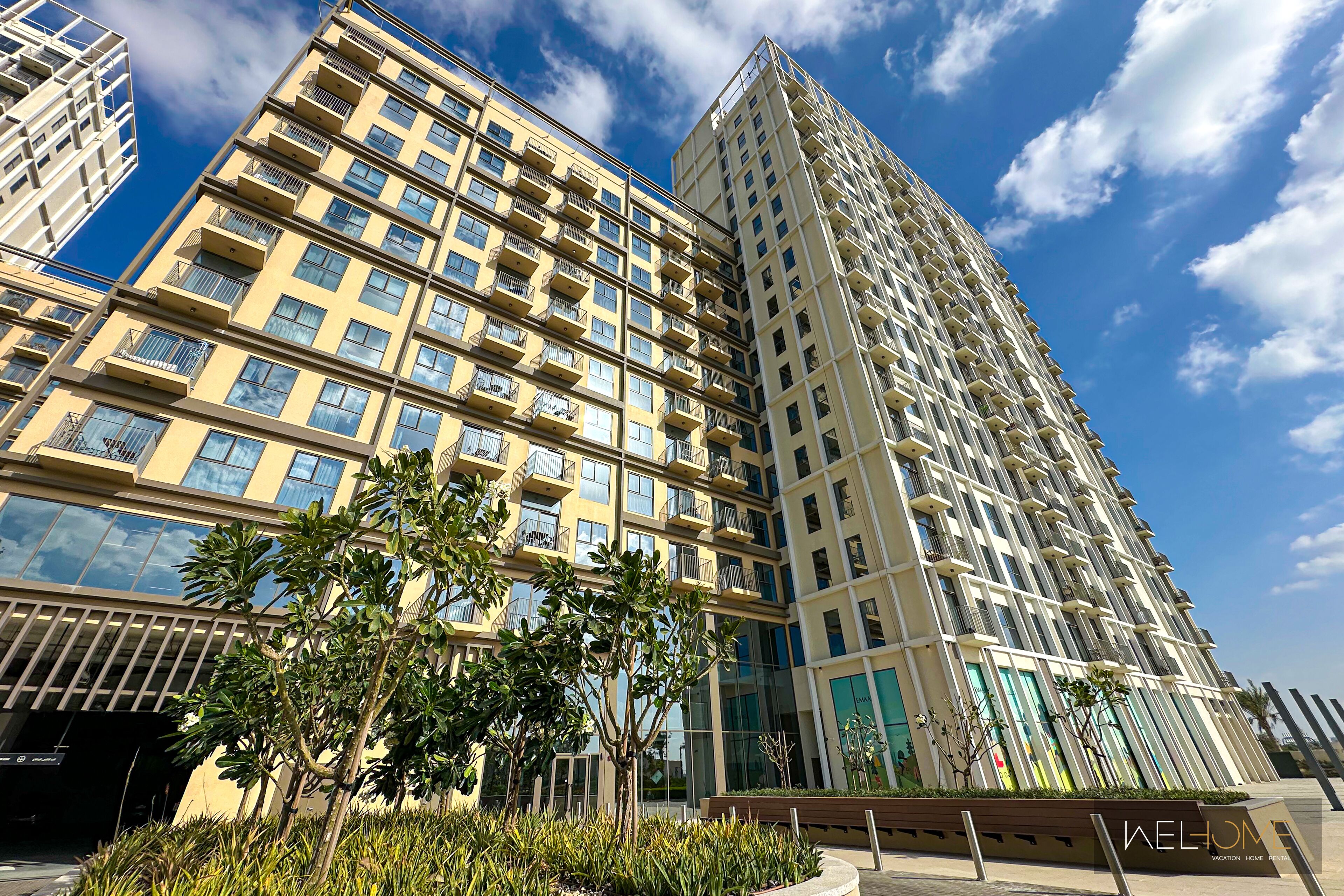 A high-rise building with multiple balconies and a modern architectural design.
