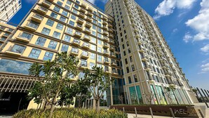 A high-rise building with multiple balconies and a modern architectural design.