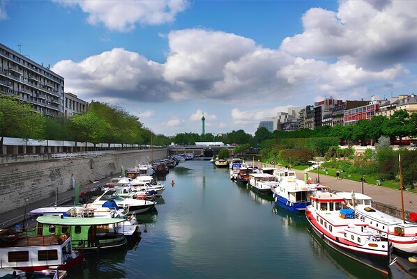 Experience the tranquil atmosphere of a serene canal scene, surrounded by a mix of modern and traditional architecture.