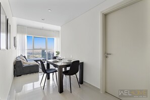 Deluxe-Apartment, Balkon, Stadtblick | Wohnbereich | 50-Zoll-Smart-TV mit Kabelempfang