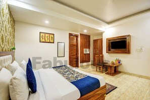 A bedroom with a bed, a desk, and a TV. - Hotel Fabulous At Delhi Airport (New Delhi)