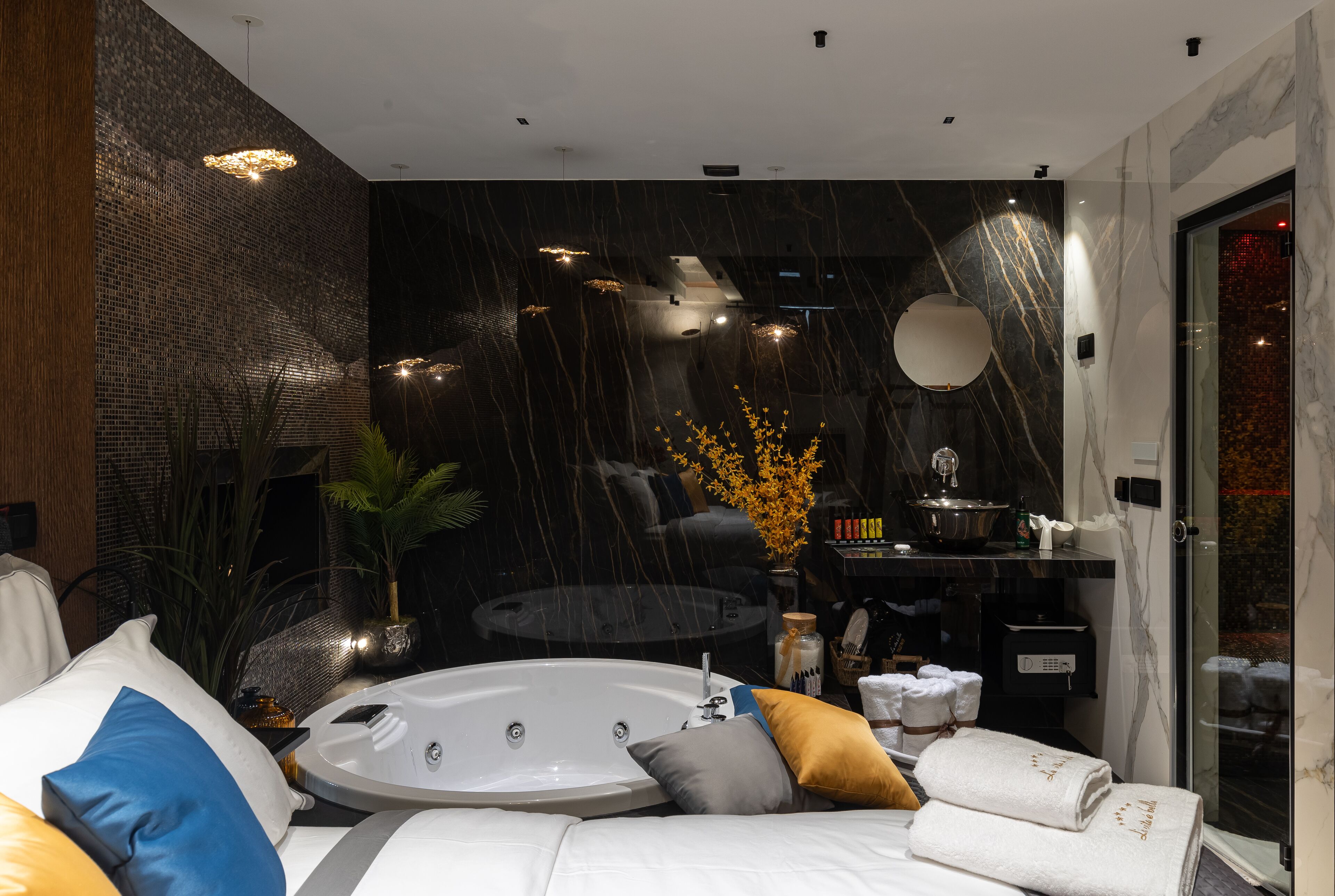 A modern bathroom with a large bathtub, a mirror, and a shower area.