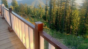 A wooden deck with a railing overlooking a forested mountain area. - Ahistay Homes, Fagu (Fagu)