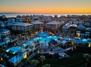 A resort with a central pool, multiple buildings, and a view of the ocean at sunset. - Cozy 3BR Beach Home, Pool & Beach Access ~ Blue Lagoon, Seacrest Beach 30A (Panama City Beach)