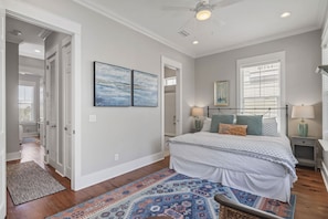 A bedroom with a bed, bedside tables, a nightstand, a ceiling fan, and a window with blinds. - Cozy 3BR Beach Home, Pool & Beach Access ~ Blue Lagoon, Seacrest Beach 30A (Panama City Beach)