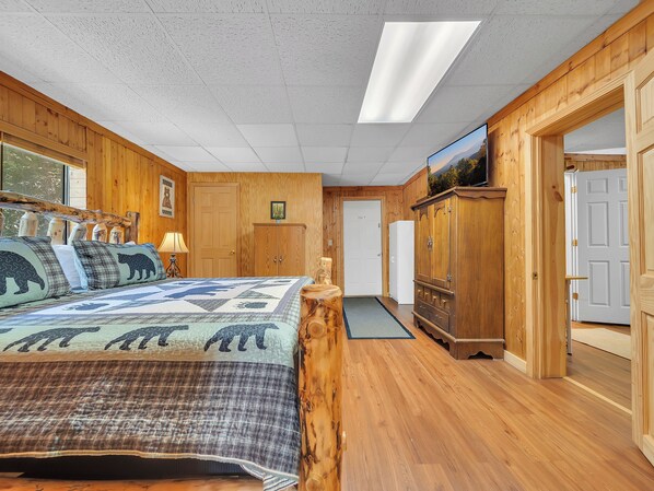 A wooden room with a bed, a dresser, and a door marked "EXIT".