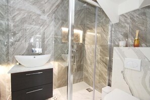 Een douche, een haardroger, een bidet, handdoeken