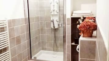 Shower, hair dryer, towels, toilet paper