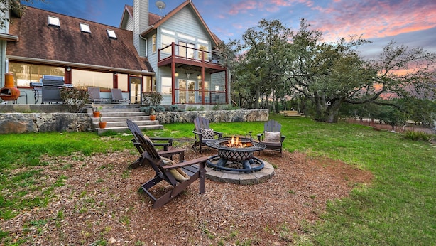 A house with a large deck, outdoor seating, and a fire pit. - Casa Robles- Bluebonnet I Firepit, couples (Wimberley)
