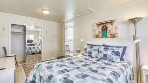 A bedroom with a bed, a desk, a chair, a wardrobe, and a mirror. - Charming Orem Home w/ Yard - Near BYU & Uvu! (Orem)