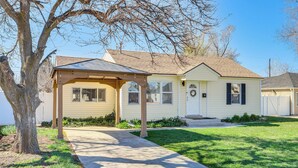A single-story house with a covered porch, a front yard, and a clear sky. - Charming Orem Home w/ Yard - Near BYU & Uvu! (Orem)