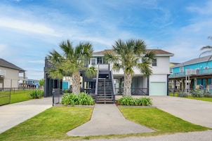 A two-story house with a front entrance, a staircase, and a small porch area.
