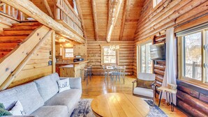 A log cabin interior with a living area, dining space, and kitchen. - Lakefront Park Rapids Cabin w/ Decks & Boat Dock! (Park Rapids)