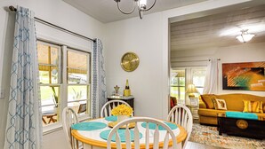 A dining area with a round table, chairs, and a clock on the wall. - Lakeview Vacation Rental - Walk to Crystal Lake! (Lakeview)