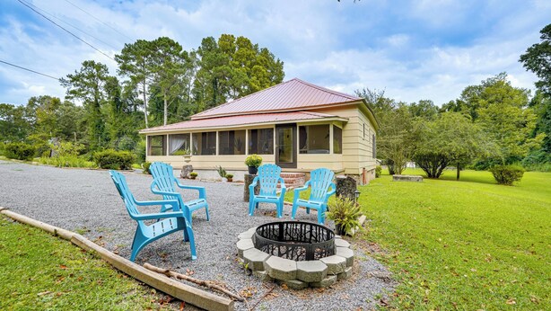 A house with a porch, outdoor seating, and a fire pit. - Lakeview Vacation Rental - Walk to Crystal Lake! (Lakeview)