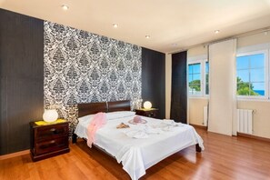Cozy retreat with a large bed, bedside tables, and lamps.