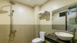 Ein Badezimmer mit Dusche, Toilette, Waschbecken und Handtuchhalter.