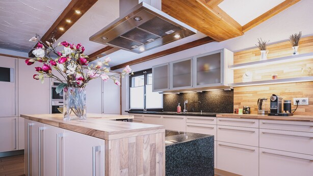 A modern kitchen with a central island, wooden beams, and a large window. - Appartements Enzian by we rent (Rauris)