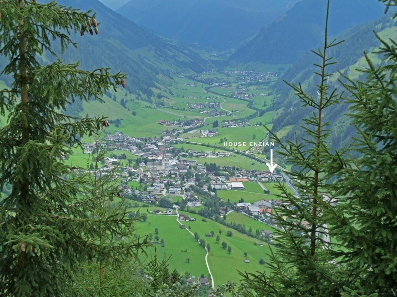 A town nestled in a valley with a prominent church and labeled 'HOUSE ENZIAN'.