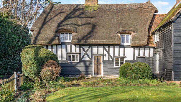 A traditional half-timbered house with a thatched roof, a wooden gate, and a well-maintained garden. - 2 bedroom accommodation in Much Hadham (Much Hadham)