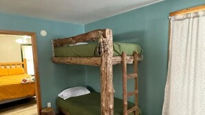 A bunk bed with a ladder, a small stool, and a mat on the floor. - Cozy Cabin- Close to all up North activities! Cabin in Irons. (Irons)