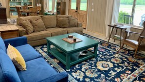 A cozy living room with a sectional sofa, a coffee table, and a patterned rug.