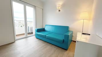 Superior Suite | Living area | 50-inch flat-screen TV with cable channels