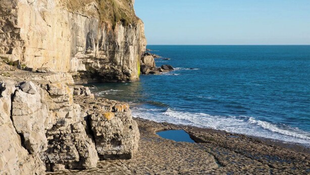 A rocky coastline with cliffs and a clear blue sea. - 2 bedroom accommodation in Acton (Acton)
