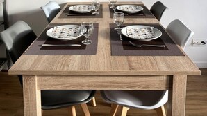 A dining table with a geometric deer head artwork above it, surrounded by black chairs and set with plates and glasses. - 150m from shops, 2nd floor, balcony, tv, ski locker, 40m², Flaine (Flaine)