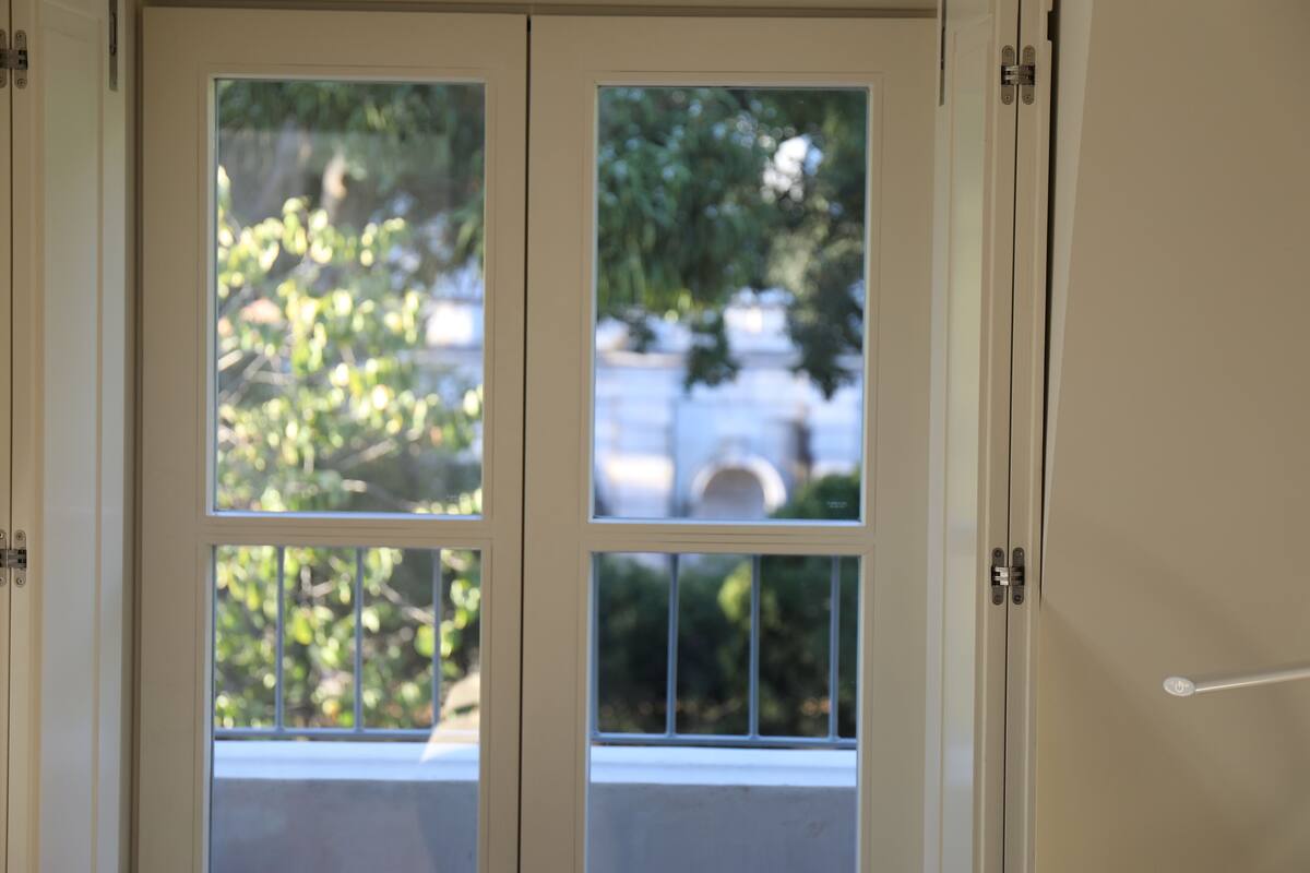 A door with a view of greenery outside.