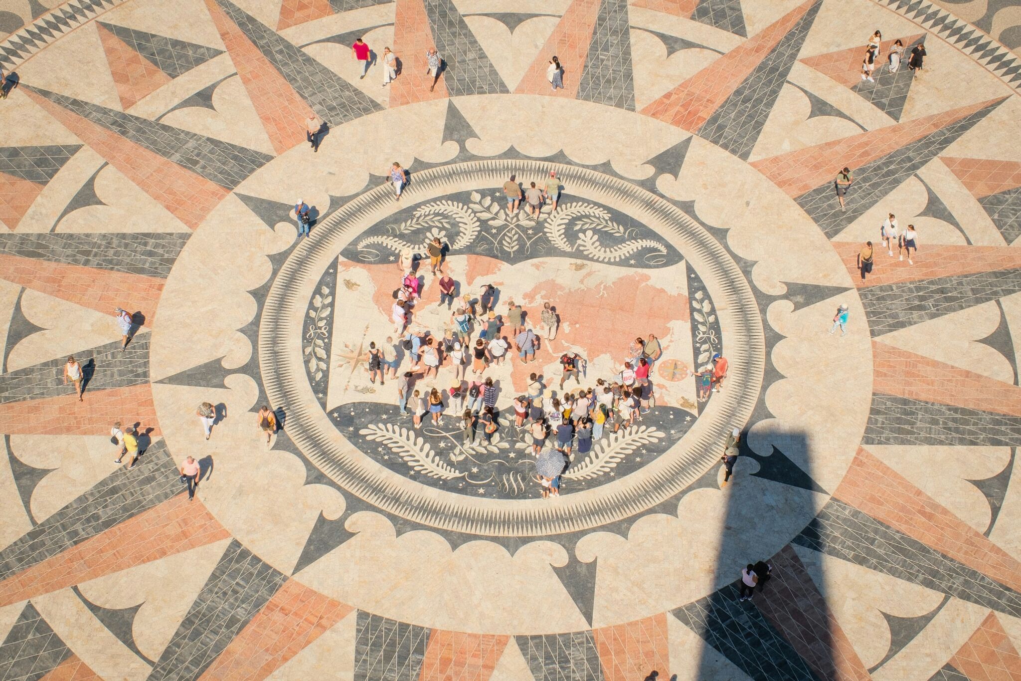 A large, ornate circular mosaic with people gathered in the center.