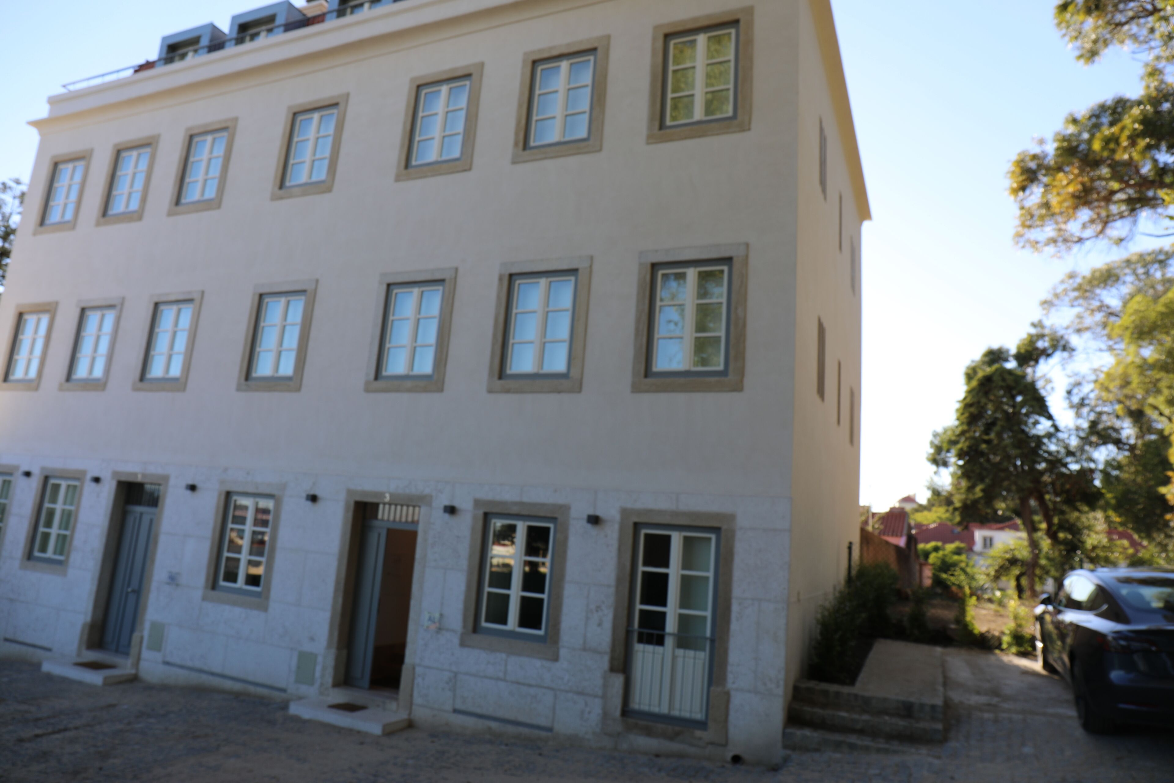 A multi-story building with a symmetrical facade, evenly spaced windows, and a flat roof.