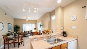 A modern kitchen with a sink, countertop, and a coffee maker. - Disney Area Condo w/ 4 Pools & Arcade Fun (Kissimmee)