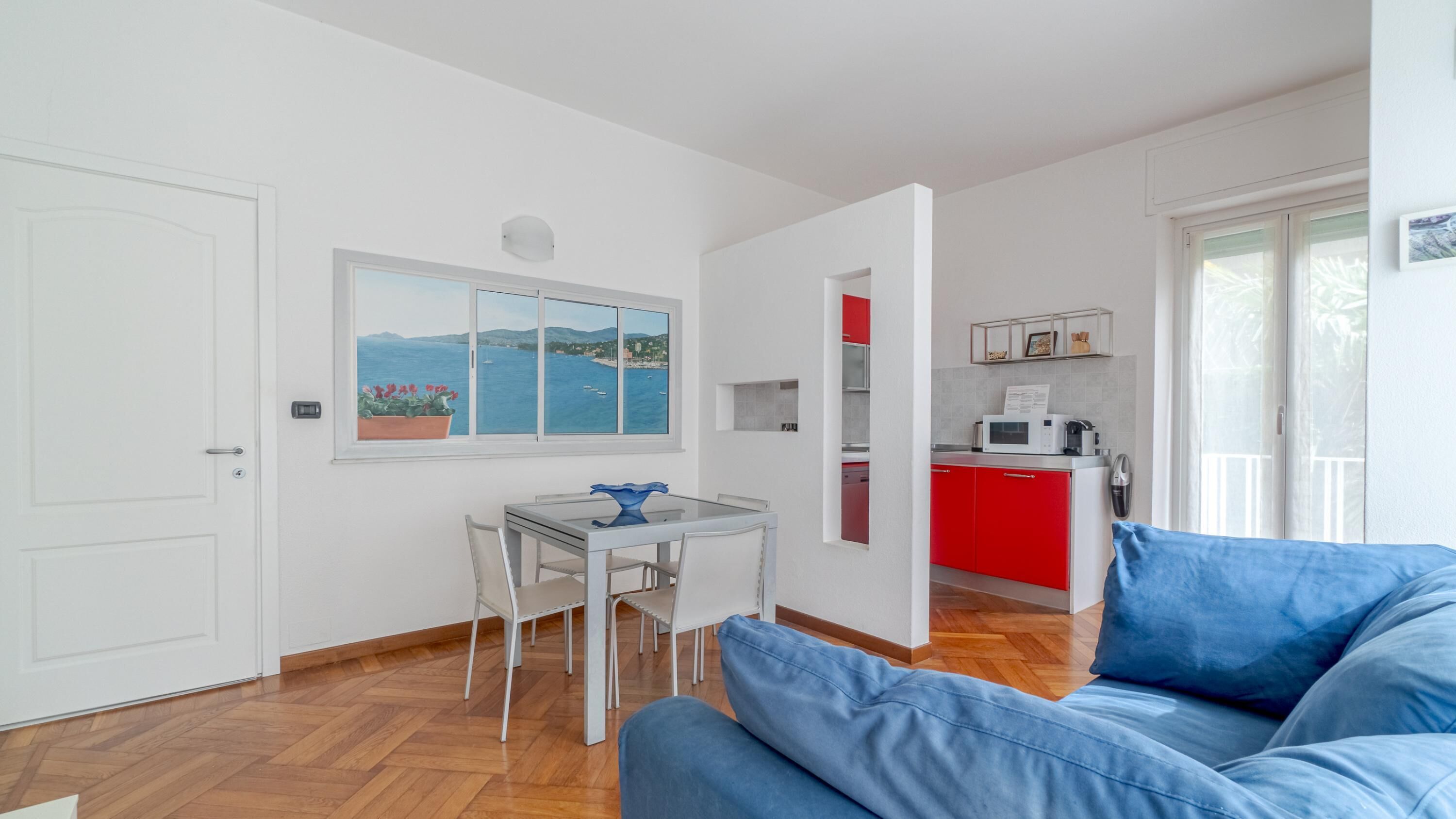 A compact living space with a dining area, a kitchenette, and a sofa.