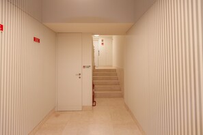 Staircase leads to an upper level with additional doors.