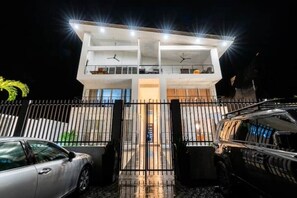 Experience the welcoming atmosphere of this two-story building, featuring a central entrance and spacious balconies for outdoor relaxation.