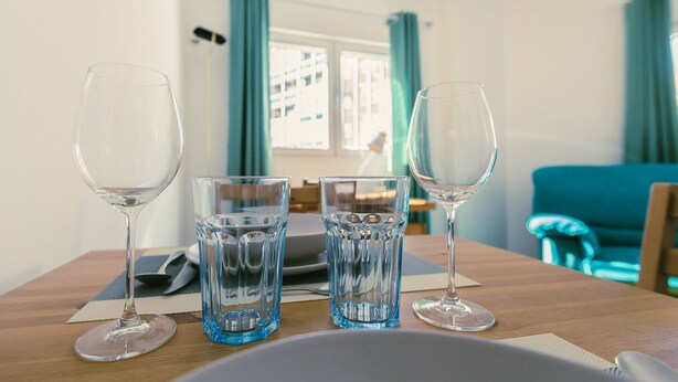 A dining table with three wine glasses and two water glasses, a laptop, and a notebook. - Madrid Rio Perfect location for exploring Madrid! Modern 1-bed flat sleeps 2. (Madrid)