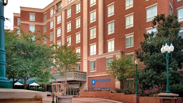 A multi-story brick building with a sign reading 'WYNDHAM.'