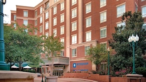 A multi-story brick building with a sign reading 'WYNDHAM.'