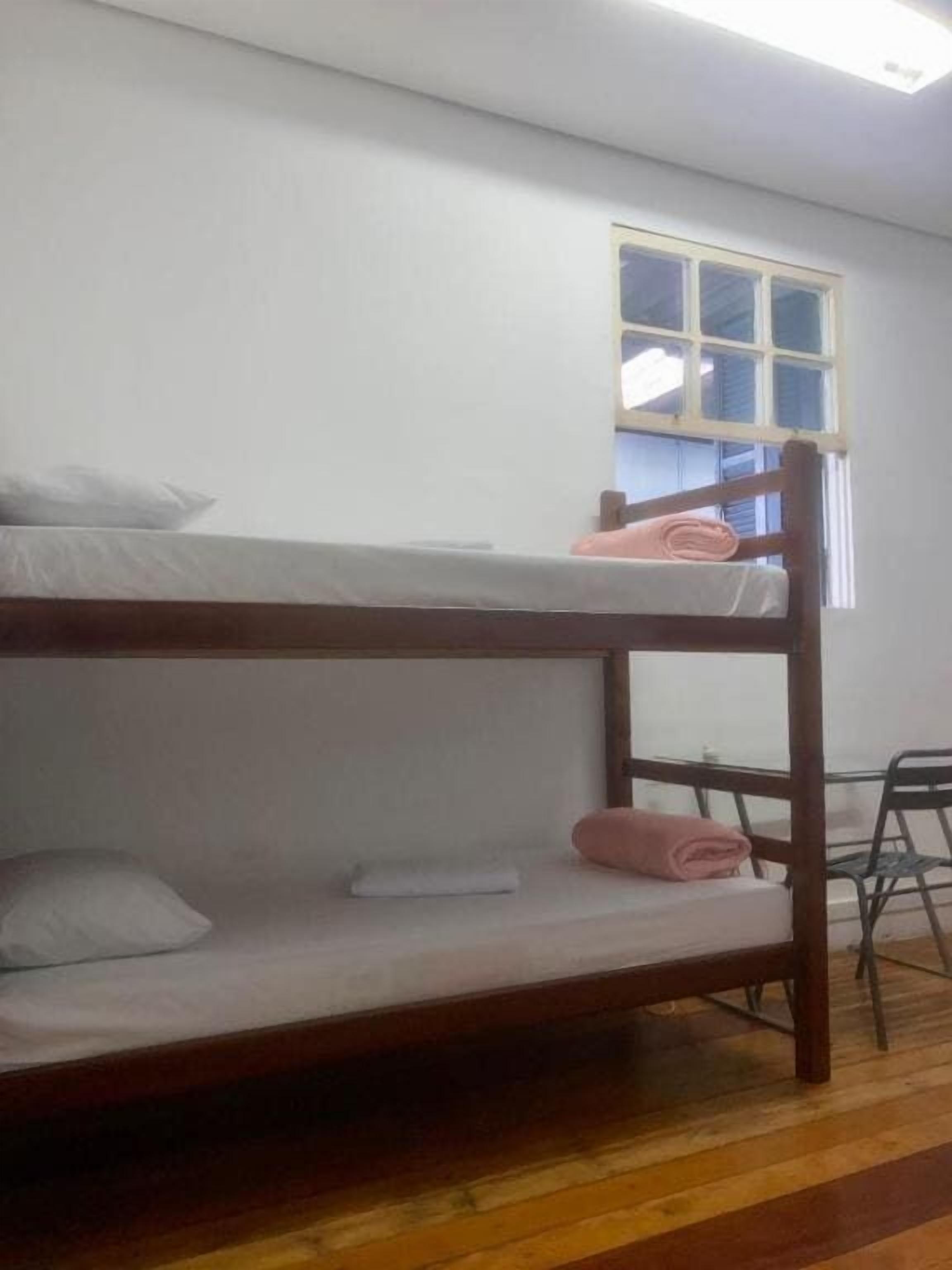 A bunk bed with pillows and a folded blanket.