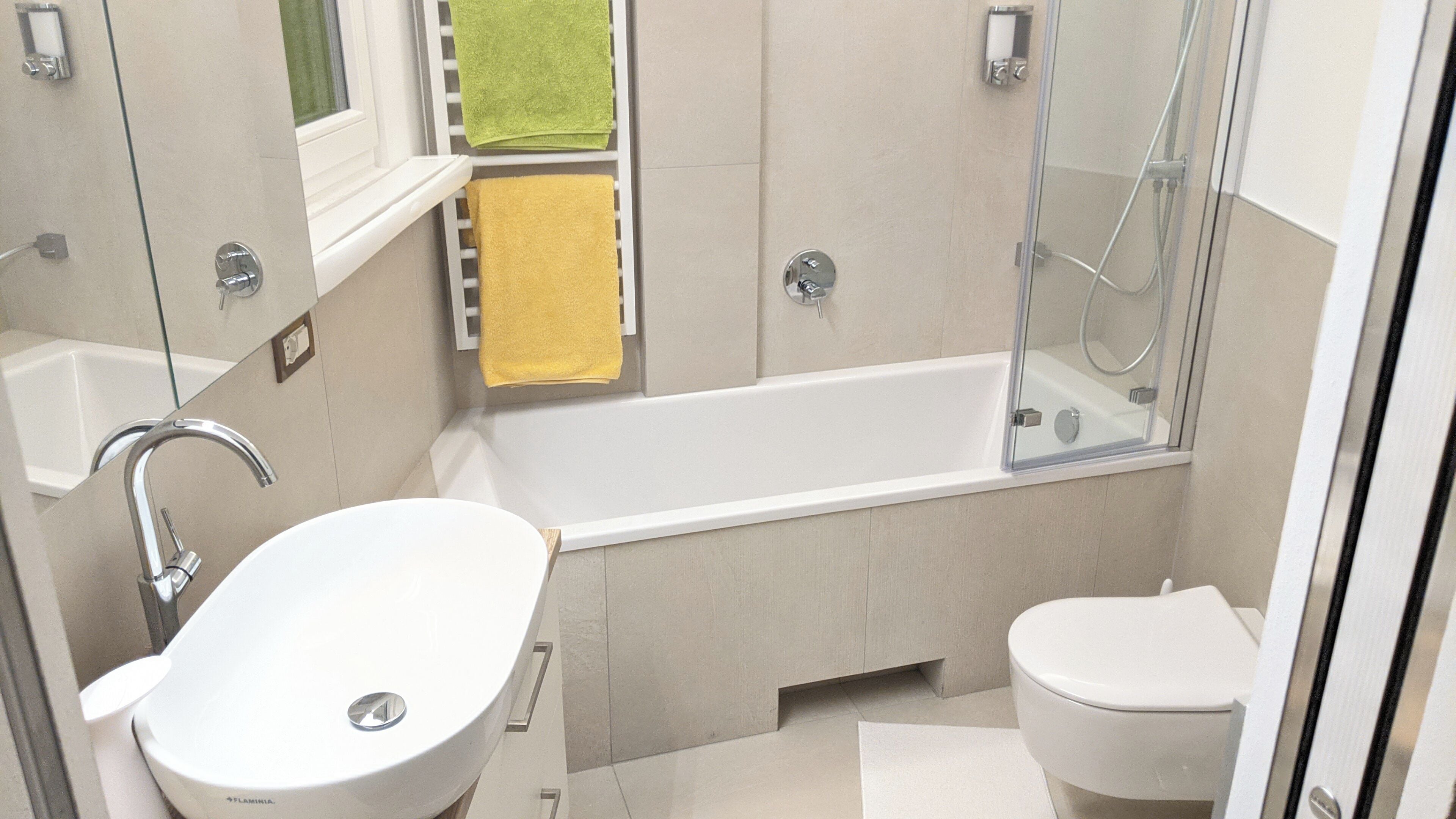A modern bathroom with a bathtub, a sink, and a toilet.