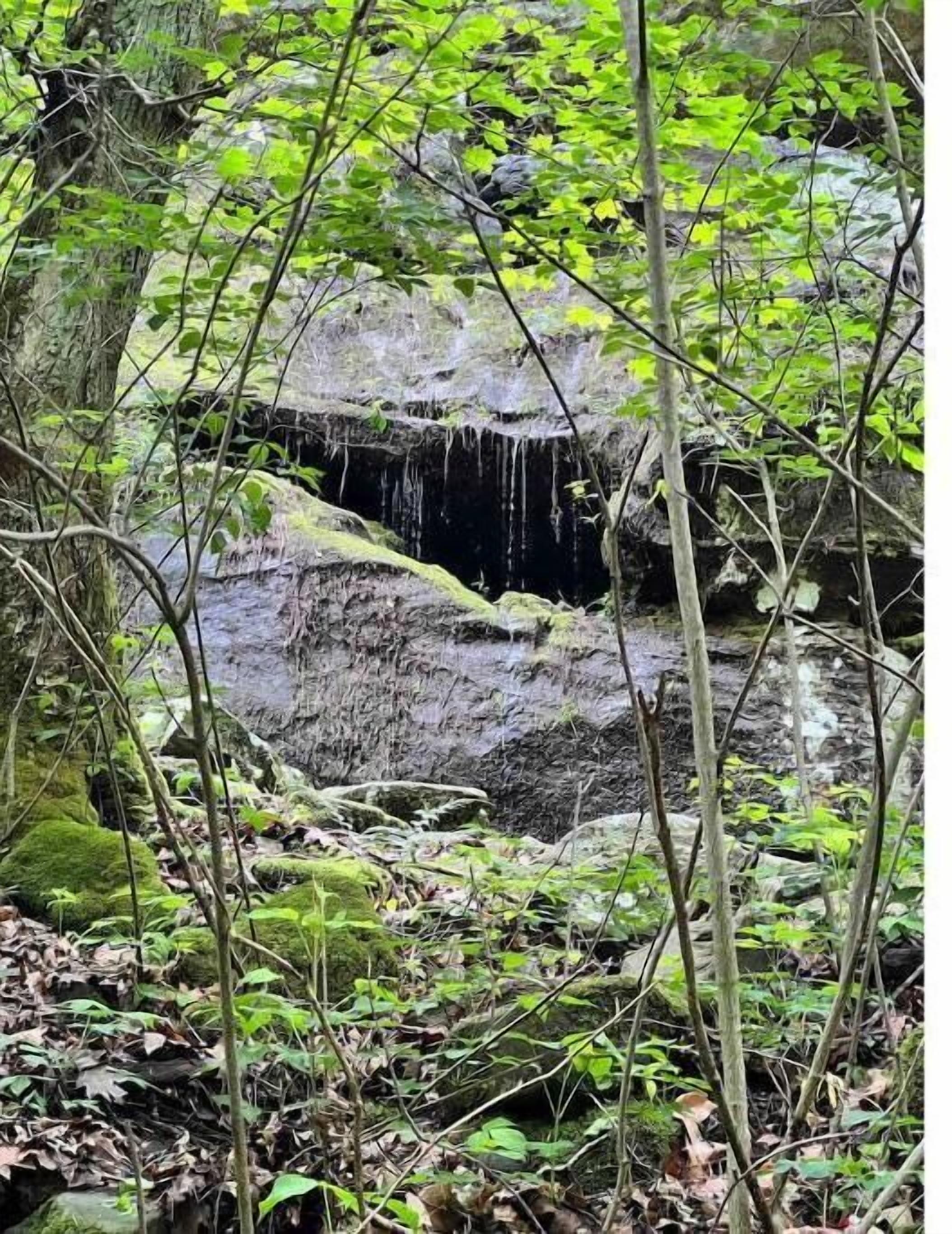 A natural rock formation with a small waterfall.