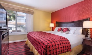 A hotel room with a bed, two bedside lamps, a dresser, and a window with curtains. - 2br Family Fun Near Disney & Knotts Berry Farm (Anaheim)