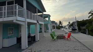 A beachfront hotel with a covered outdoor seating area, a pool, and a view of the ocean. - Endless Summer Beach House
 (Cudjoe Key)