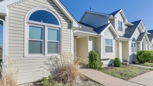 A row of single-story houses with a similar architectural style, featuring gabled roofs and a front porch. - Wichita Townhome w/ Patio: 9 Mi to Downtown! (Wichita)