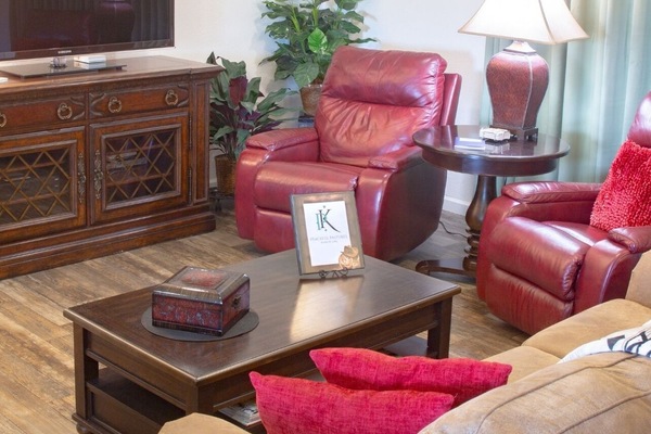 Living room with Roku TV, 2 recliners, 1 sofa, 1 rocking chair