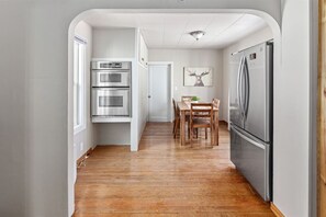 Enjoy cooking in this well-equipped kitchen with a central island, double ovens, and dining area.